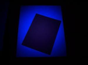 smaller 1930s photo on top of a 2000 photo, showing the difference in fluorescence under black light